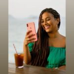 woman smiling about an ecard she received from a friend, through Lovebox, on her phone.
