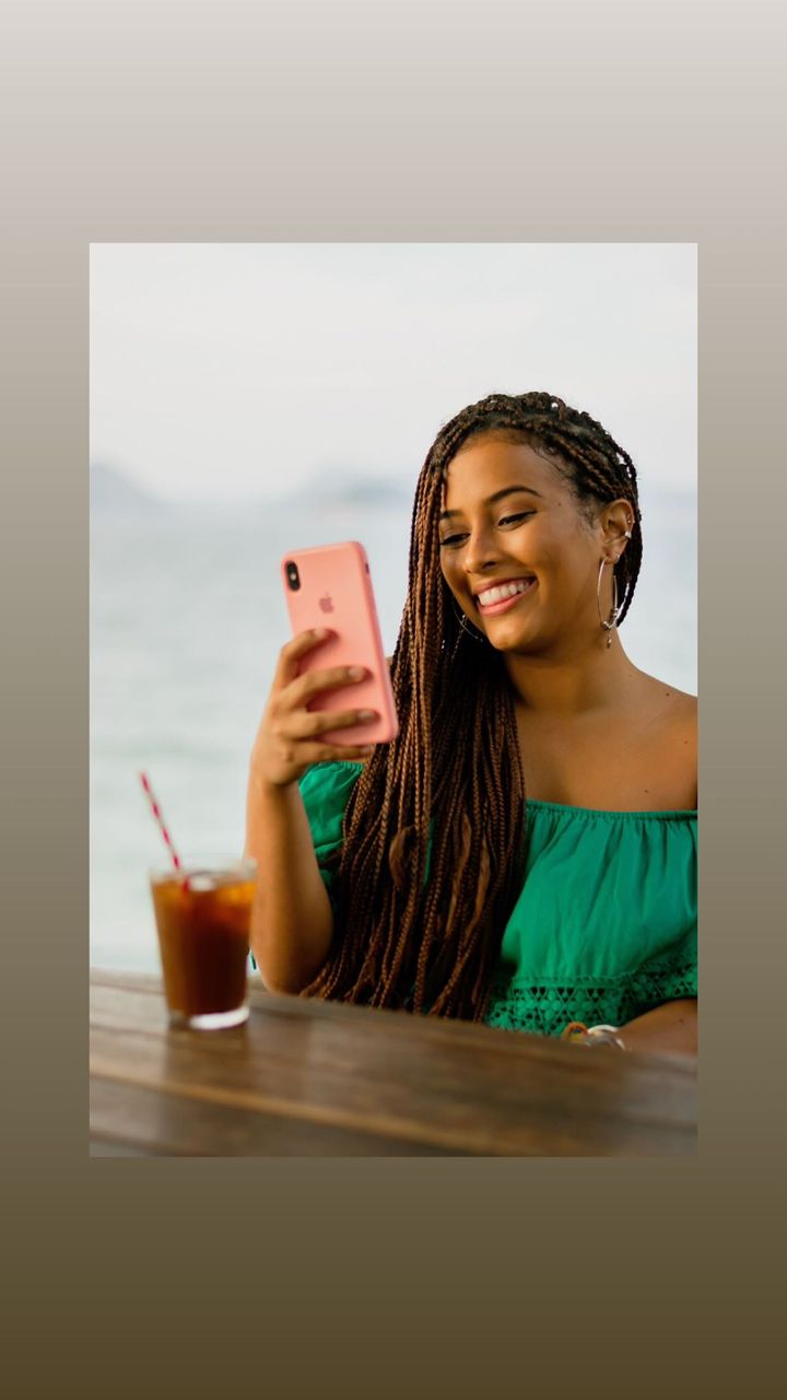 woman smiling about an ecard she received from a friend, through Lovebox, on her phone.